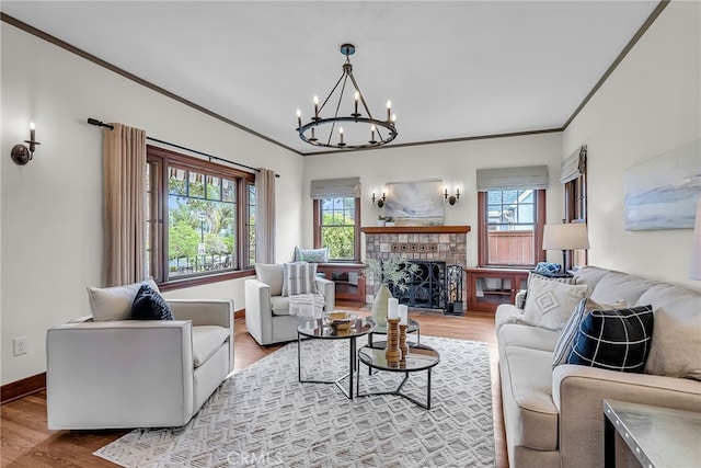 4775 Somerset Dr, Riverside, CA 92507 - living area with ornamental molding, a chandelier, wood finished floors, baseboards, and a tile fireplace