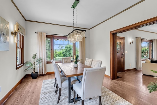 4775 Somerset Dr, Riverside, CA 92507 - dining space featuring ornamental molding, wood finished floors, baseboards, a chandelier, and healthy amount of natural light