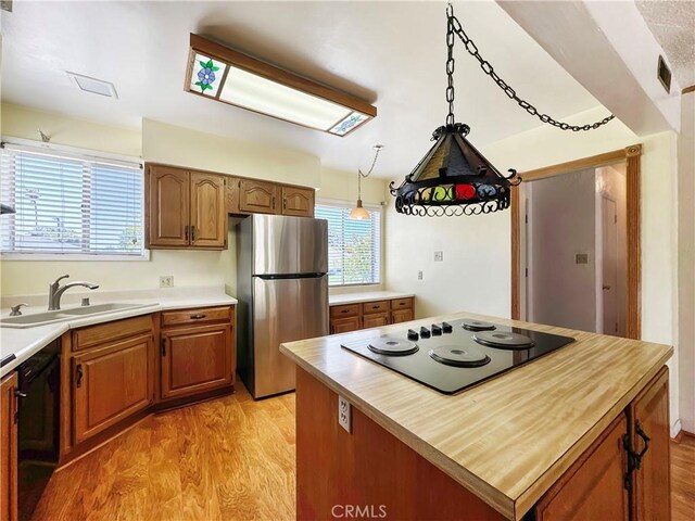 817 W Heber St, Glendora, CA 91741 - kitchen featuring black appliances, a sink, light wood finished floors, brown cabinets, and butcher block countertops
