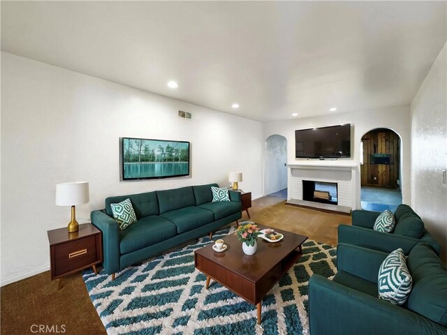 817 W Heber St, Glendora, CA 91741 - carpeted living area featuring arched walkways, recessed lighting, and a fireplace with raised hearth