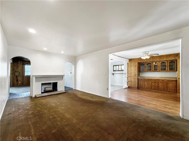 817 W Heber St, Glendora, CA 91741 - unfurnished living room with arched walkways, carpet flooring, a brick fireplace, baseboards, and recessed lighting