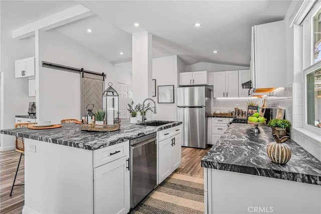 803 Spencer St, Redondo Beach, CA 90277 - kitchen with stainless steel appliances, a sink, a barn door, light wood-style floors, and recessed lighting