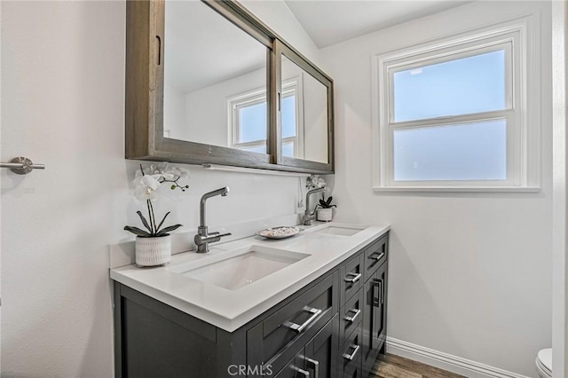 803 Spencer St, Redondo Beach, CA 90277 - bathroom featuring double vanity, toilet, baseboards, and wood finished floors
