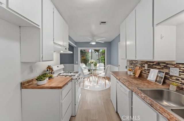 1317 Via Santiago Unit C, Corona, CA 92882 - kitchen featuring white appliances, under cabinet range hood, a sink, and white cabinetry