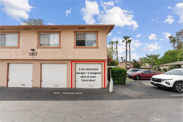 1317 Via Santiago Unit C, Corona, CA 92882 - view of front facade featuring stucco siding and uncovered parking