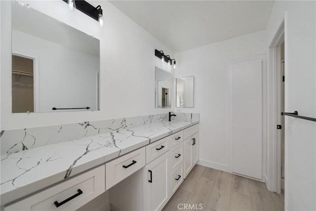 3180 Little Mountain Dr Unit D, San Bernardino, CA 92405 - bathroom with double vanity and wood finished floors