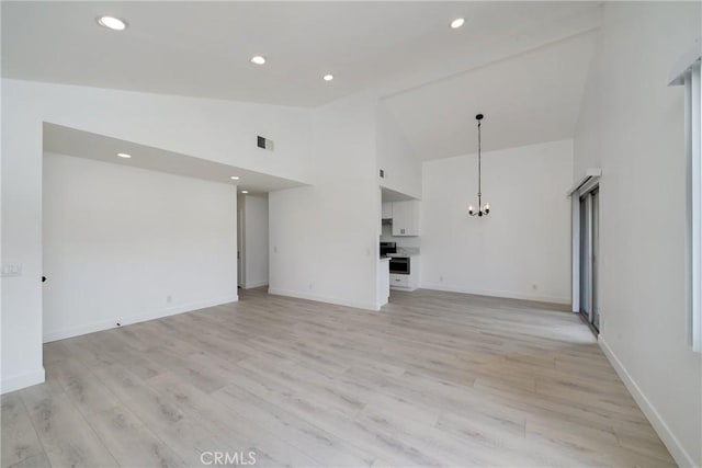 3180 Little Mountain Dr Unit D, San Bernardino, CA 92405 - unfurnished living room with a chandelier, high vaulted ceiling, light wood-style flooring, baseboards, and recessed lighting