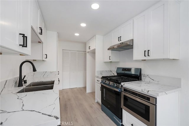 3180 Little Mountain Dr Unit D, San Bernardino, CA 92405 - kitchen featuring stainless steel gas range oven, under cabinet range hood, a sink, recessed lighting, and white cabinetry