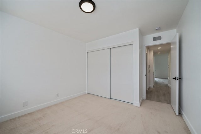 3180 Little Mountain Dr Unit D, San Bernardino, CA 92405 - unfurnished bedroom featuring light colored carpet, baseboards, and a closet