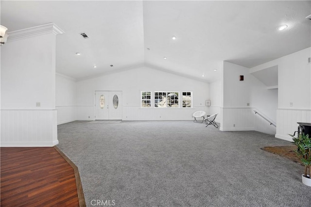 unfurnished living room featuring a wainscoted wall, carpet flooring, vaulted ceiling, and recessed lighting