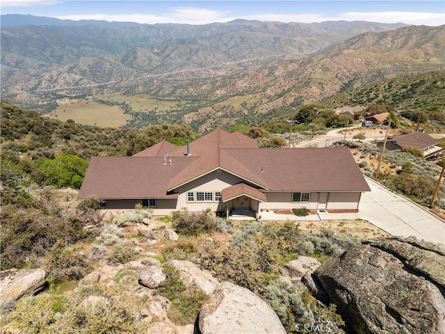 aerial view of property and surrounding area featuring a mountain backdrop