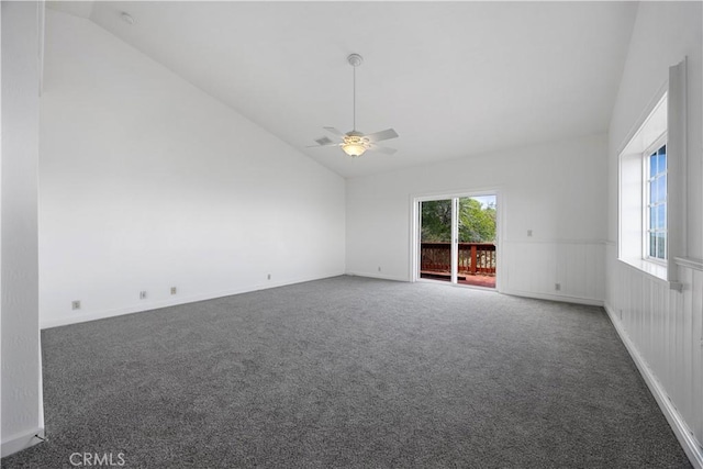 carpeted empty room with vaulted ceiling and ceiling fan