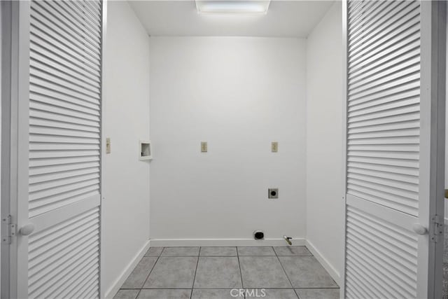 clothes washing area with electric dryer hookup, light tile patterned floors, baseboards, and hookup for a washing machine