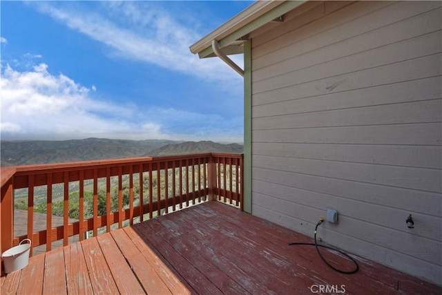 wooden deck with a mountain view