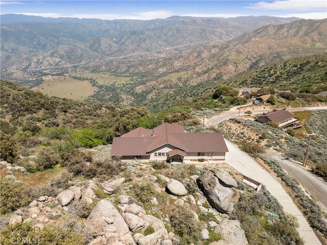 aerial view of property and surrounding area with a mountain backdrop