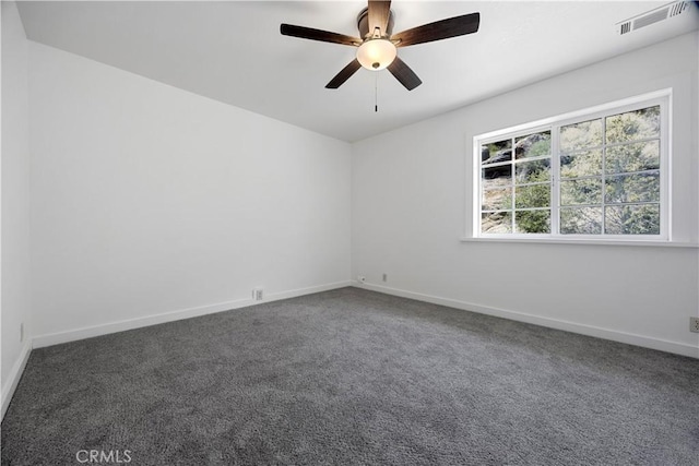 unfurnished room featuring carpet, a ceiling fan, and baseboards