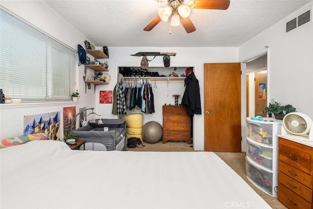 1825 Magnolia Ave, Chico, CA 95926 - carpeted bedroom featuring a closet, a textured ceiling, and a ceiling fan
