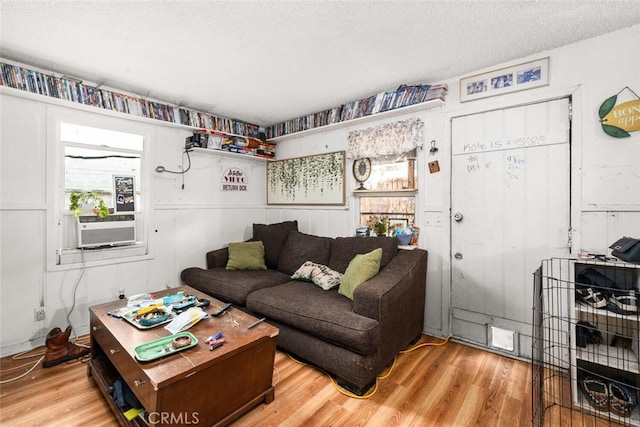 1825 Magnolia Ave, Chico, CA 95926 - living area with plenty of natural light, wood finished floors, a textured ceiling, and cooling unit