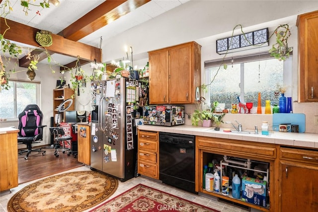 1825 Magnolia Ave, Chico, CA 95926 - kitchen with black dishwasher, stainless steel fridge, brown cabinets, light countertops, and a desk