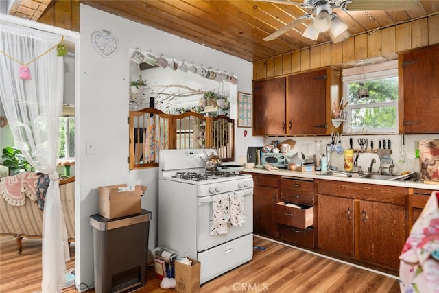 1825 Magnolia Ave, Chico, CA 95926 - kitchen featuring gas range gas stove, wooden ceiling, light countertops, light wood-style flooring, and a ceiling fan