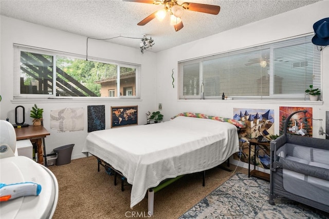 1825 Magnolia Ave, Chico, CA 95926 - bedroom featuring a textured ceiling, carpet, and a ceiling fan