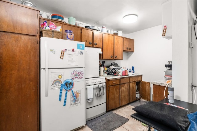 1825 Magnolia Ave, Chico, CA 95926 - kitchen featuring white appliances, brown cabinets, light countertops, and light tile patterned floors