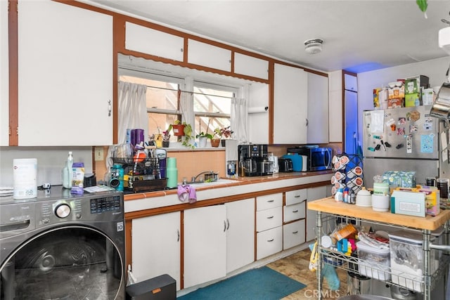 1825 Magnolia Ave, Chico, CA 95926 - kitchen featuring washer / clothes dryer, freestanding refrigerator, tile counters, and white cabinetry