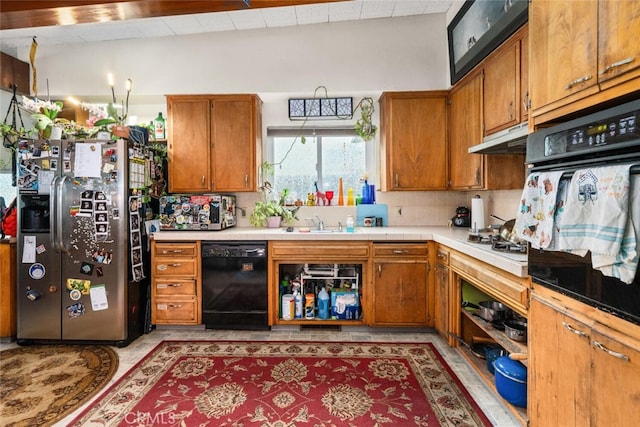 1825 Magnolia Ave, Chico, CA 95926 - kitchen with black appliances, brown cabinets, under cabinet range hood, and decorative backsplash