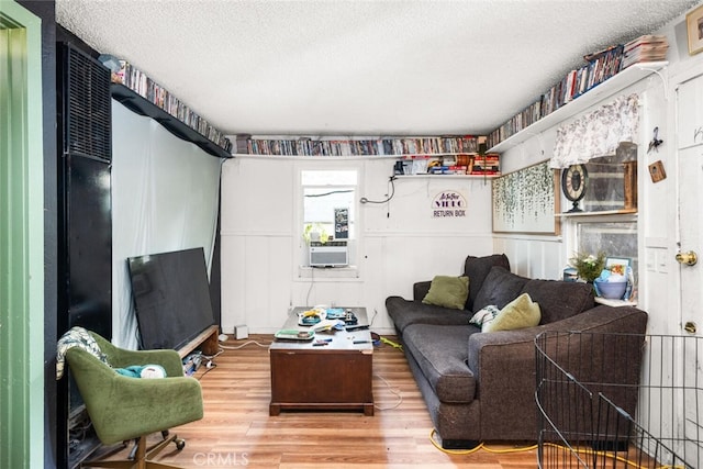 1825 Magnolia Ave, Chico, CA 95926 - living area featuring a textured ceiling, wood finished floors, and cooling unit
