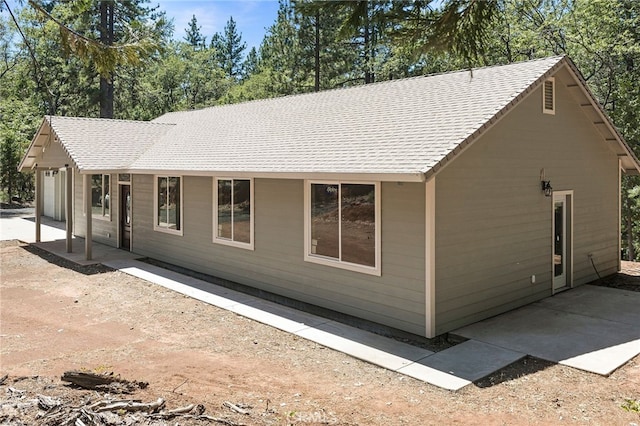 4901 Papaya Rd, Forest Ranch, CA 95942 - view of front of home featuring an attached garage, a patio, and roof with shingles