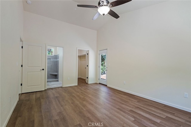 4901 Papaya Rd, Forest Ranch, CA 95942 - unfurnished bedroom with high vaulted ceiling, wood finished floors, baseboards, a spacious closet, and ensuite bathroom