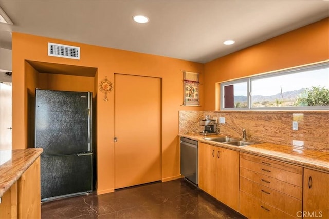 kitchen with freestanding refrigerator, a sink, stainless steel dishwasher, decorative backsplash, and recessed lighting