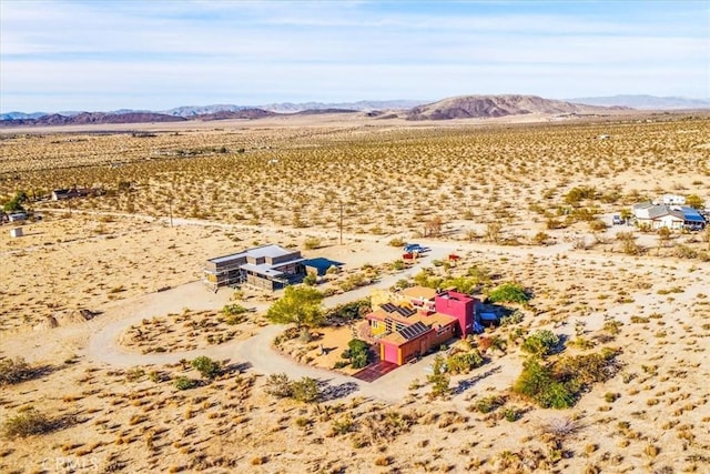 aerial view of sparsely populated area featuring a desert landscape and mountains