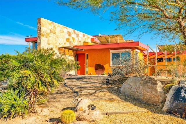 pueblo revival-style home featuring stucco siding