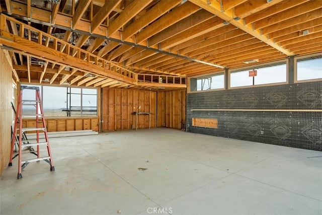 7078 Sunkist Rd, Joshua Tree, CA 92252 - miscellaneous room with unfinished concrete floors and a garage