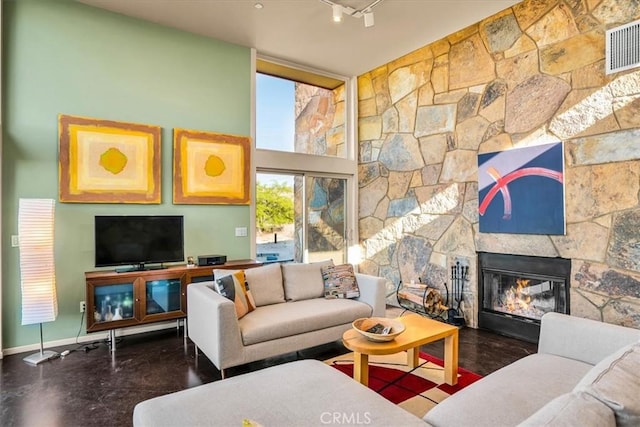 living room featuring a fireplace and baseboards