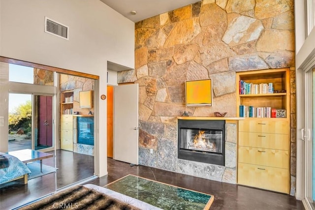 living area featuring a large fireplace and a high ceiling