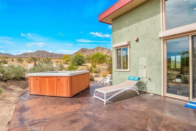 7078 Sunkist Rd, Joshua Tree, CA 92252 - view of patio featuring a hot tub and a mountain view