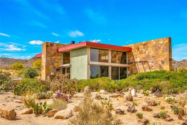 7078 Sunkist Rd, Joshua Tree, CA 92252 - view of side of property featuring stone siding and stucco siding