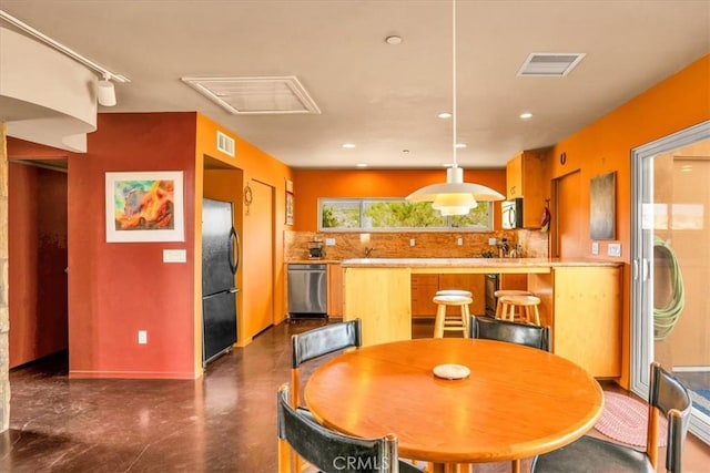 dining room with recessed lighting, attic access, baseboards, and concrete floors
