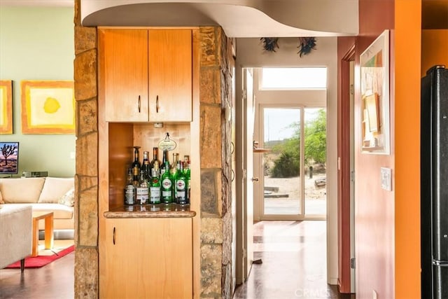 bar area featuring refrigerator
