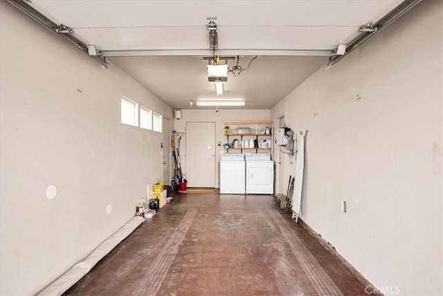 garage featuring separate washer and dryer and a garage door opener