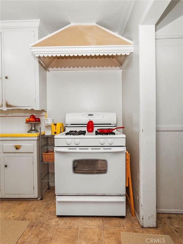 137 N Rose St, Burbank, CA 91505 - kitchen featuring white gas stove, white cabinetry, premium range hood, and light countertops