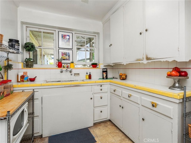 137 N Rose St, Burbank, CA 91505 - kitchen with tasteful backsplash, white cabinetry, and tile counters