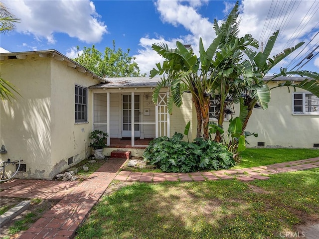 137 N Rose St, Burbank, CA 91505 - view of exterior entry featuring crawl space and a yard