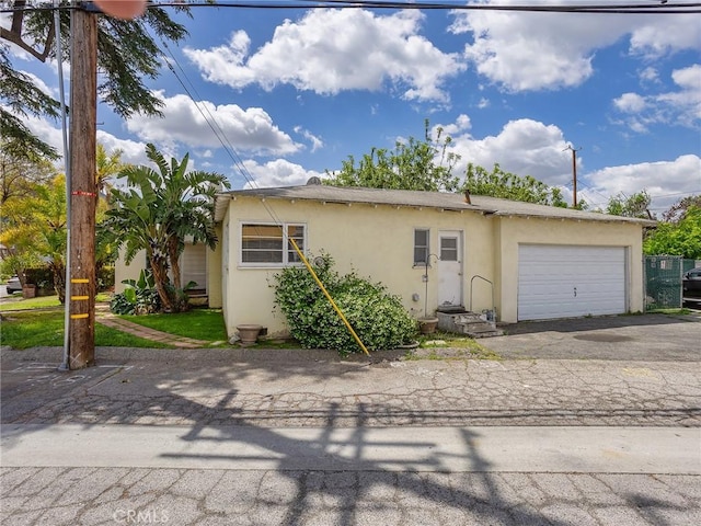 137 N Rose St, Burbank, CA 91505 - view of front of house with stucco siding, an attached garage, and driveway