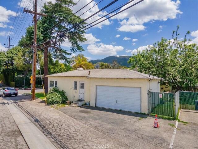 137 N Rose St, Burbank, CA 91505 - view of side of home with a mountain view, stucco siding, and fence