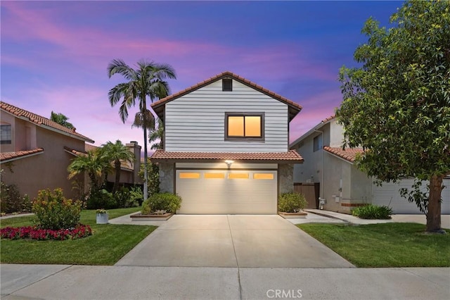15 Vittoria St, Laguna Niguel, CA 92677 - traditional-style home with an attached garage, a tiled roof, driveway, and a yard