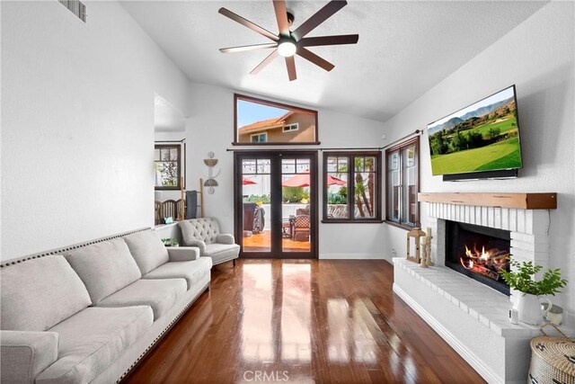 15 Vittoria St, Laguna Niguel, CA 92677 - living area with vaulted ceiling, ceiling fan, wood finished floors, baseboards, and a brick fireplace