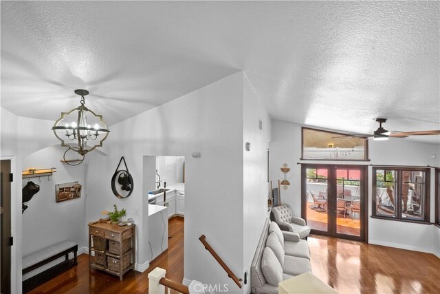 15 Vittoria St, Laguna Niguel, CA 92677 - hallway featuring a textured ceiling, wood finished floors, a chandelier, an upstairs landing, and baseboards